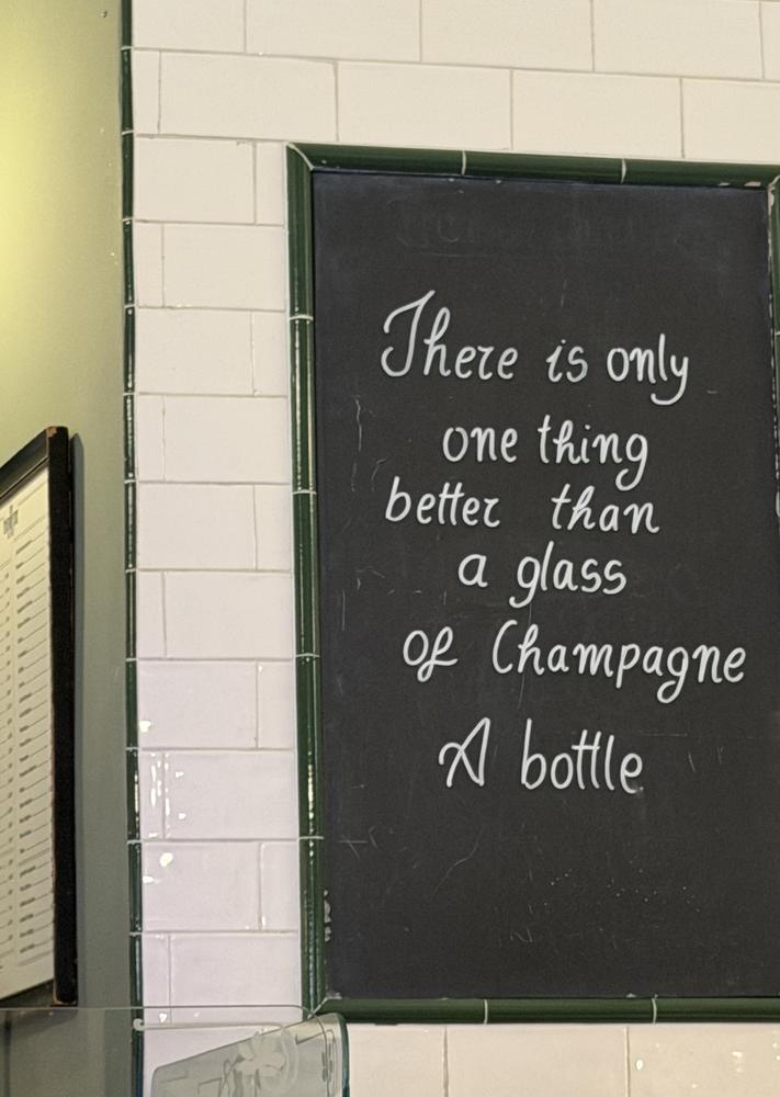 A chalkboard: there is only one thing better than a glass of Champagne. A bottle.