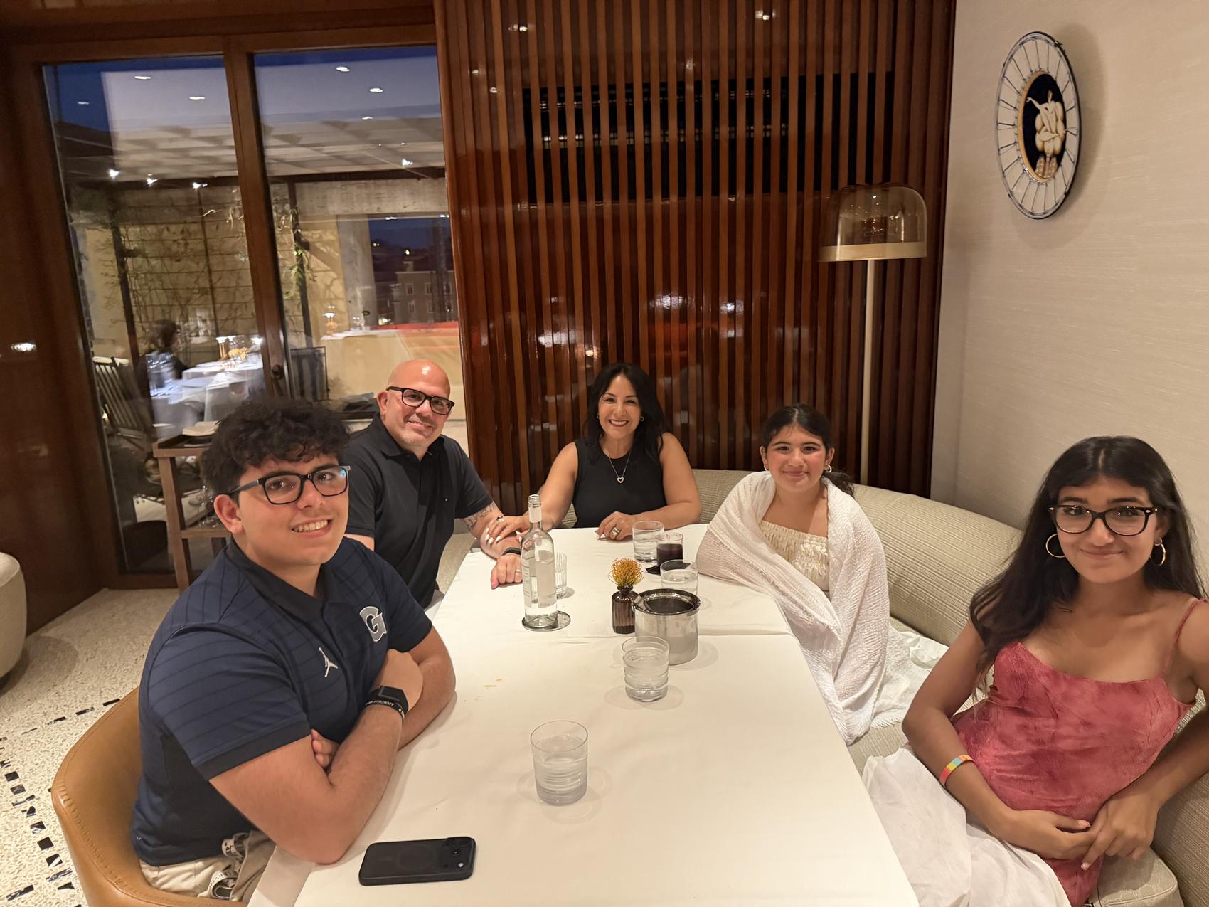 Elena, Eric and their three children at dinner in Rome